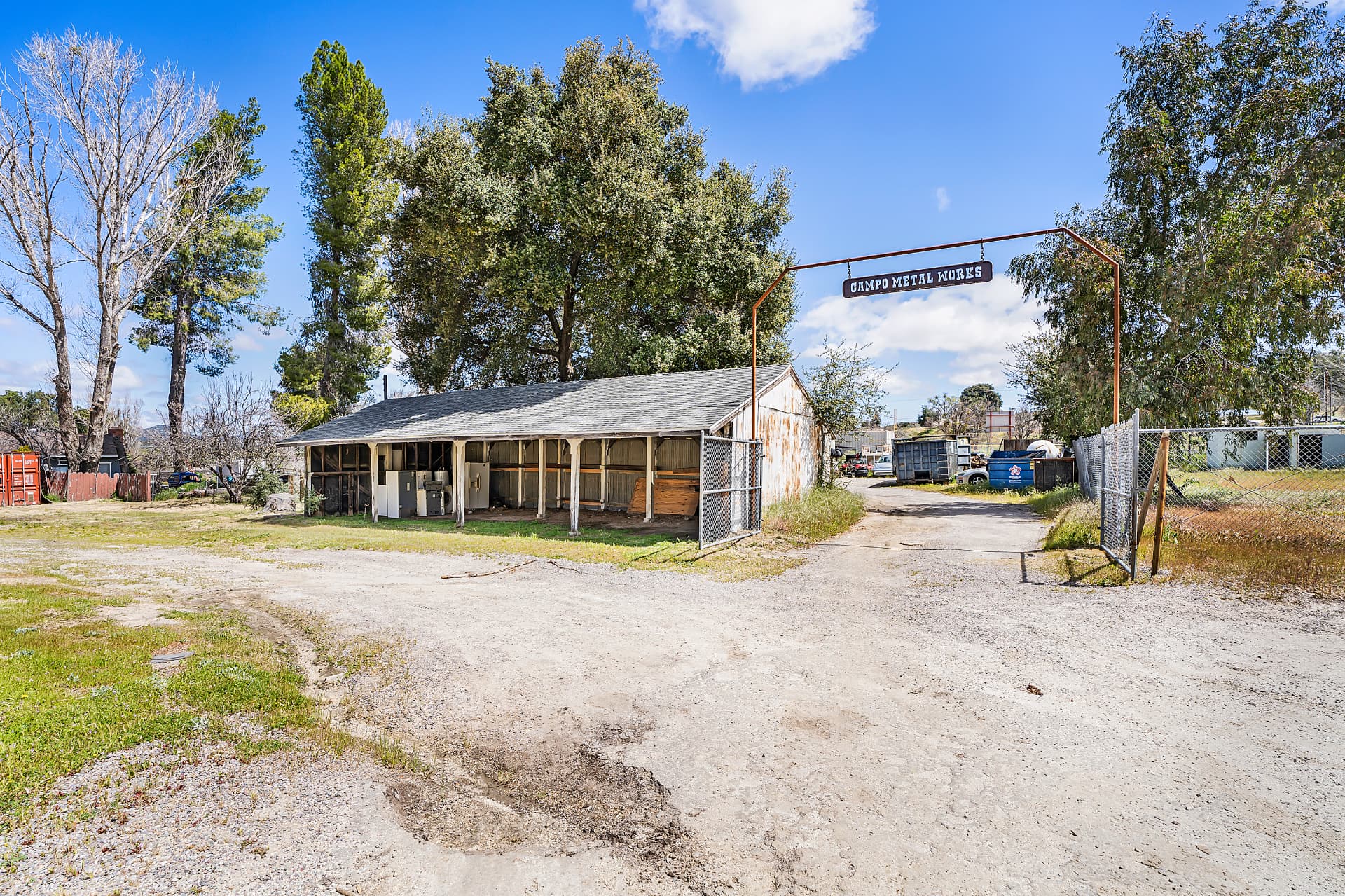 Open-bay metal works shed beneath a Campo Metal Works sign